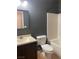 Bathroom with tiled floors, dark wall paint, dark cabinets, mirror, and a shower/tub combo at 8212 Calico Wind St, Las Vegas, NV 89131