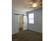 Bedroom with barn door leading to walk-in closet, neutral carpet, and natural light at 8212 Calico Wind St, Las Vegas, NV 89131
