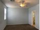 Spacious bedroom with neutral carpet, ceiling fan and ensuite bathroom at 8212 Calico Wind St, Las Vegas, NV 89131
