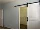 Bedroom with barn door leading to a walk-in closet at 8212 Calico Wind St, Las Vegas, NV 89131