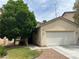 Charming single-Gathering home with a two-car garage and a lush green lawn at 8212 Calico Wind St, Las Vegas, NV 89131