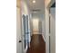 Long hallway with dark wood floors and white doors at 8212 Calico Wind St, Las Vegas, NV 89131