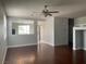 Open-concept living room with dark hardwood floors and abundant natural light at 8212 Calico Wind St, Las Vegas, NV 89131