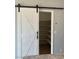 Convenient pantry featuring ample shelving and a modern sliding barn door at 8212 Calico Wind St, Las Vegas, NV 89131