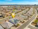 Aerial view of the neighborhood with a pin marking the property location and scenic mountain views at 9032 Skye Canyon Ranch St, Las Vegas, NV 89166