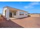 A view of the patio, sliding glass doors, and gravel-covered backyard space at 9032 Skye Canyon Ranch St, Las Vegas, NV 89166