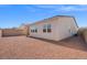 A view of the backyard showing the gravel-covered space with some privacy walls at 9032 Skye Canyon Ranch St, Las Vegas, NV 89166