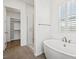 Bright bathroom featuring a standalone tub and a glass shower enclosure at 9032 Skye Canyon Ranch St, Las Vegas, NV 89166