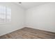 Bedroom featuring wood flooring, white walls, and plantation shutters at 9032 Skye Canyon Ranch St, Las Vegas, NV 89166