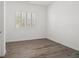 Bedroom with wood flooring, white walls, and a window with plantation shutters at 9032 Skye Canyon Ranch St, Las Vegas, NV 89166