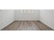 Bedroom featuring wood flooring, white walls, and plantation shutters at 9032 Skye Canyon Ranch St, Las Vegas, NV 89166