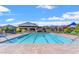 Large community pool with a recreation area, lounge chairs, and a view of the surrounding Skye Canyon landscape at 9032 Skye Canyon Ranch St, Las Vegas, NV 89166
