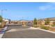 View of the community gate with brick columns and landscaping, providing privacy at 9032 Skye Canyon Ranch St, Las Vegas, NV 89166