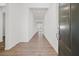Long and bright hallway with wood floors that leads to other rooms at 9032 Skye Canyon Ranch St, Las Vegas, NV 89166
