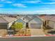 A view of the home showcasing the front exterior, landscaping, and two-car garage at 9032 Skye Canyon Ranch St, Las Vegas, NV 89166