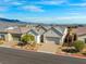 This is a shot of the home, highlighting the landscaping and the paved driveway at 9032 Skye Canyon Ranch St, Las Vegas, NV 89166