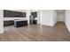 Open-concept kitchen with dark wood cabinetry, stainless steel appliances, and a center island at 9032 Skye Canyon Ranch St, Las Vegas, NV 89166