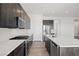 Contemporary kitchen with a white marble backsplash, stainless steel appliances, and a center island at 9032 Skye Canyon Ranch St, Las Vegas, NV 89166