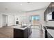 The open-concept kitchen leads to the dining and living areas, with backyard access at 9032 Skye Canyon Ranch St, Las Vegas, NV 89166
