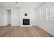 Living room with a fireplace and shuttered windows at 9032 Skye Canyon Ranch St, Las Vegas, NV 89166