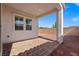 Covered patio area featuring a brick paved seating area and adjacent gravel landscape at 9032 Skye Canyon Ranch St, Las Vegas, NV 89166