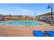 Resort-style pool area with lounge chairs, covered seating, and inviting blue water at 9032 Skye Canyon Ranch St, Las Vegas, NV 89166