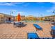 The community pool features plenty of tables, chairs, umbrellas and lounge seating at 9032 Skye Canyon Ranch St, Las Vegas, NV 89166