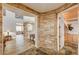 Elegant foyer features stone accents, hardwood floors, staircase, and entry to an adjacent room at 9204 Brownstone Ledge Ave, Las Vegas, NV 89149