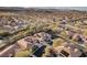 Expansive aerial view of a desert neighborhood, with tile roofs and mountain backdrop at 10129 Elk Valley St, Las Vegas, NV 89178