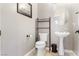 Cozy powder room featuring pedestal sink, bronze fixtures and neutral color palette at 10129 Elk Valley St, Las Vegas, NV 89178