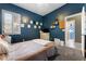 Comfortable bedroom with a blue wall, carpet and large window at 10129 Elk Valley St, Las Vegas, NV 89178