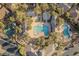 Aerial view of a sparkling community pool area featuring a large pool, ' area and mature trees at 10129 Elk Valley St, Las Vegas, NV 89178