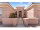 Elegant home entrance with a decorative wrought iron gate and a neatly maintained front garden at 10129 Elk Valley St, Las Vegas, NV 89178