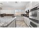 Kitchen with granite counters, stainless appliances, and white cabinets at 10129 Elk Valley St, Las Vegas, NV 89178