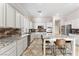 Spacious kitchen features granite countertops, white cabinetry, and large island with seating at 10129 Elk Valley St, Las Vegas, NV 89178