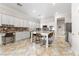 Bright kitchen featuring white cabinetry, granite countertops, and a central island with bar seating at 10129 Elk Valley St, Las Vegas, NV 89178