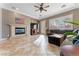 Cozy living room featuring a fireplace, TV, and ample seating with natural light from the windows at 10129 Elk Valley St, Las Vegas, NV 89178