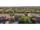 An aerial view of a suburban home with desert landscaping including lush greenery in a well maintained neighborhood at 10288 Grizzly Forest Dr, Las Vegas, NV 89178