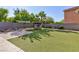 Picturesque backyard featuring a lush lawn, cozy fire pit, and outdoor dining area for ultimate relaxation and entertainment at 10288 Grizzly Forest Dr, Las Vegas, NV 89178