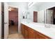 Bright bathroom with double sinks, tiled floor, and views into two separate rooms at 10288 Grizzly Forest Dr, Las Vegas, NV 89178