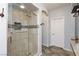 Bathroom features a glass shower, tile floors, and large arched entryway at 10288 Grizzly Forest Dr, Las Vegas, NV 89178