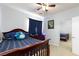 Bedroom with dark wood furniture, plush blue pillows, and a mirrored closet at 10288 Grizzly Forest Dr, Las Vegas, NV 89178