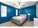Bedroom with blue walls, carpet, windows and bed, plus ceiling fan at 10288 Grizzly Forest Dr, Las Vegas, NV 89178