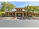 Exterior view of a community clubhouse showcasing its craftsman style architecture, mature trees and landscaped grounds at 10288 Grizzly Forest Dr, Las Vegas, NV 89178