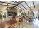 The interior showcases a cozy lounge with a stone fireplace, chandeliers, and wood beam ceilings at 10288 Grizzly Forest Dr, Las Vegas, NV 89178