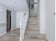 Entryway features wood look floors, a staircase, and a white front door at 10288 Grizzly Forest Dr, Las Vegas, NV 89178