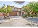 Charming two-story home with a three-car garage and well-manicured front yard at 10288 Grizzly Forest Dr, Las Vegas, NV 89178