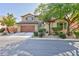 Charming two-story home with a two car garage, desert landscaping and blue shutters on the upper level windows at 10288 Grizzly Forest Dr, Las Vegas, NV 89178