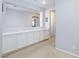 Hallway featuring built-in cabinets with white doors and neutral colored walls and carpet at 10288 Grizzly Forest Dr, Las Vegas, NV 89178