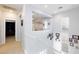 Bright upper hallway with white railings, neutral carpet and decor at 10288 Grizzly Forest Dr, Las Vegas, NV 89178